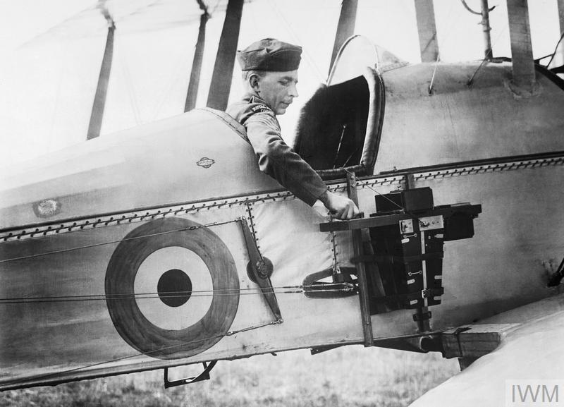 A sergeant of the Royal Flying Corps demonstrates an aerial reconnaissance camera 1916. © IWM (Q 33850)