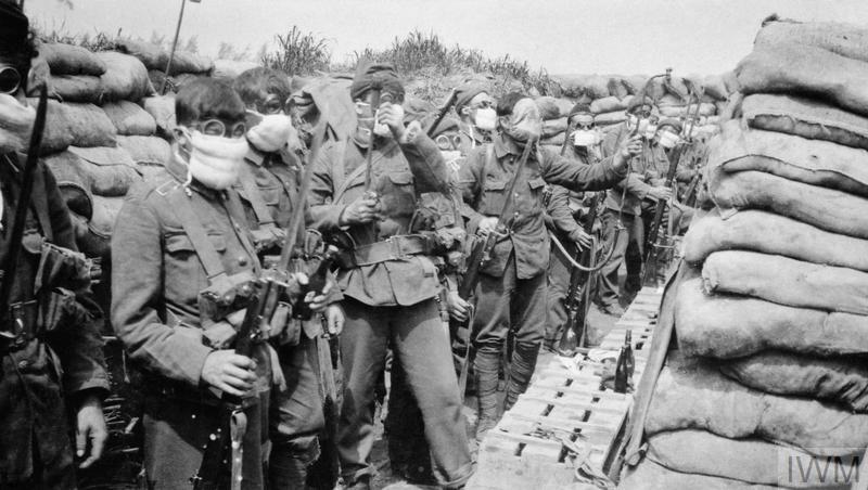 Men preparing for a gas attack. © IWM (Q 51650)