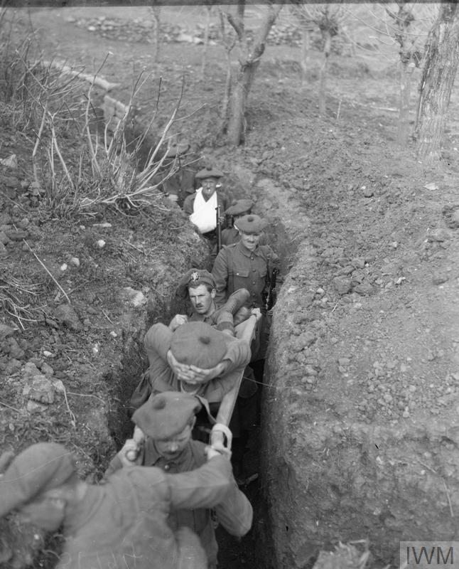 Casualties from a Scottish infantry battalion of 77th Brigade being evacuated along a communication trench outside Salonika, February 1916.© IWM (Q 31794)