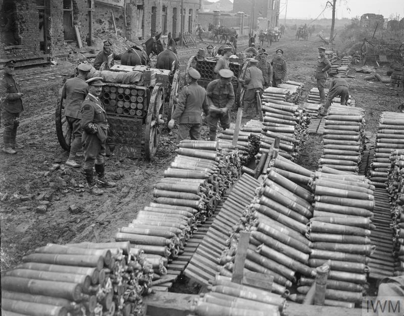 Men forming a roadside dump of 18-pounder shells 15 October 1918. © IWM (Q 9609)