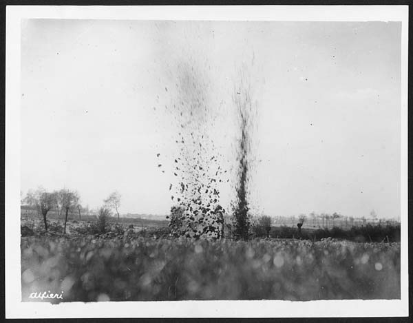 Shelling near the British trenches, Western Front, during World War I. This photograph must have been taken by one of the official war photographers as it appears to have been shot from inside a frontline trench. National Library of Scotland License: CC BY 4.0
