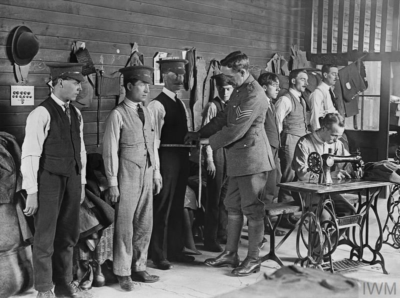 New recruits to the British Army are measured for their uniforms during the First World War. © IWM (Q 30069)