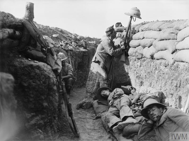 A Royal Irish Fusilier attempts to draw the fire of a Turkish sniper to reveal the enemy position, Gallipoli, 1915 - IWM © IWM (Q 13447)