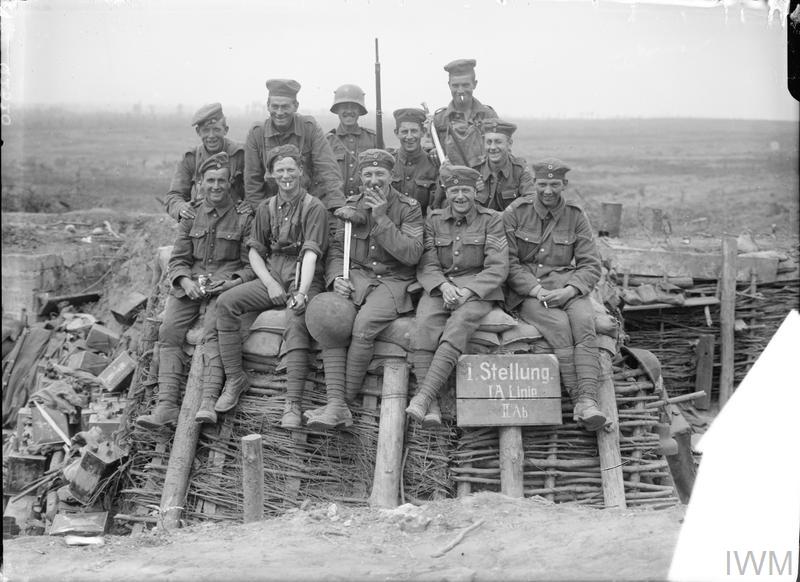  Troops of the Duke of Cornwall's Light Infantry who captured this trench, 11th June 1917. They are wearing German helmets or caps. ©IWM Q 2820
