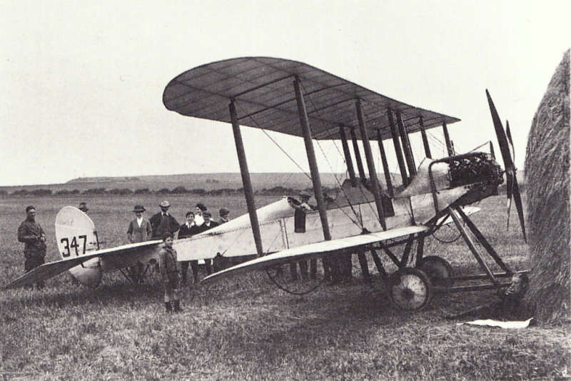 Lieutenant H D Harvey-Kelly seen resting by the haystack, was the first British pilot to land in France after the outbreak of war. CC BY-SA 3.0