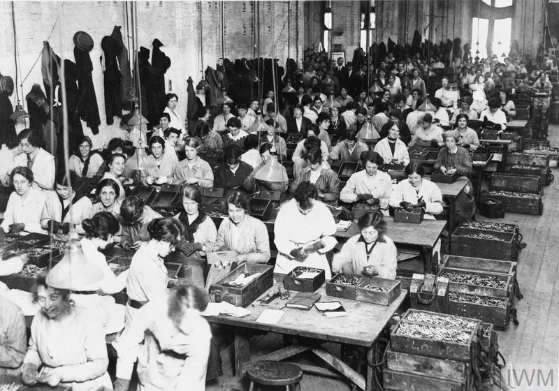 Female workers in the examination room where cartridges and bullets are given their final inspection. © IWM (Q 110355)